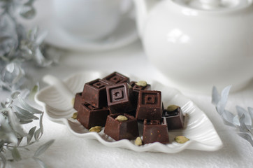 Homemade chocolates with a teapot and a cup of coffee
