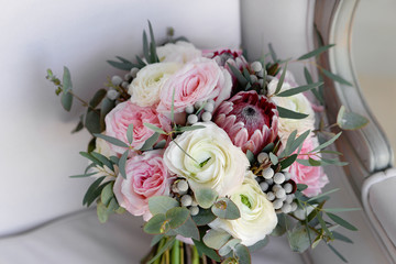 Wedding flowers, bridal bouquet closeup. Decoration made of roses, peonies and decorative plants, close-up, selective focus, nobody, objects