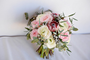Wedding flowers, bridal bouquet closeup. Decoration made of roses, peonies and decorative plants, close-up, selective focus, nobody, objects