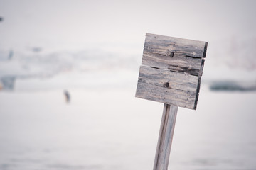 Empty wooden sign on background nature of Antarctica.