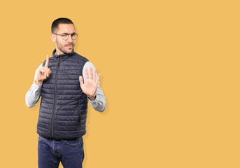 Haughty young man making a contemptuous gesture