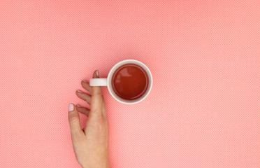 Hot healthy cup of tea in woman's hands 