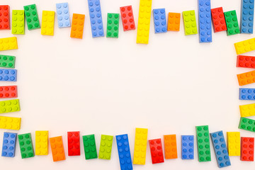 Plastic bricks for kids in different colors on the table