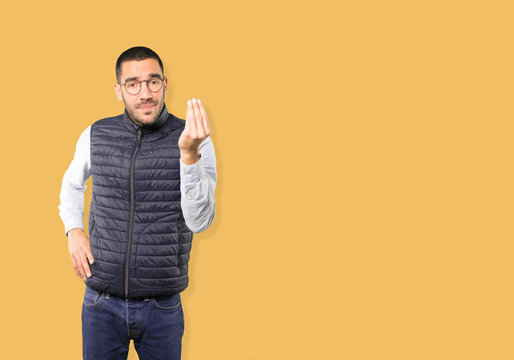 Confused young man making an italian gesture of not understand - Powered by Adobe