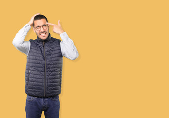 Depressed young man making a suicide gesture