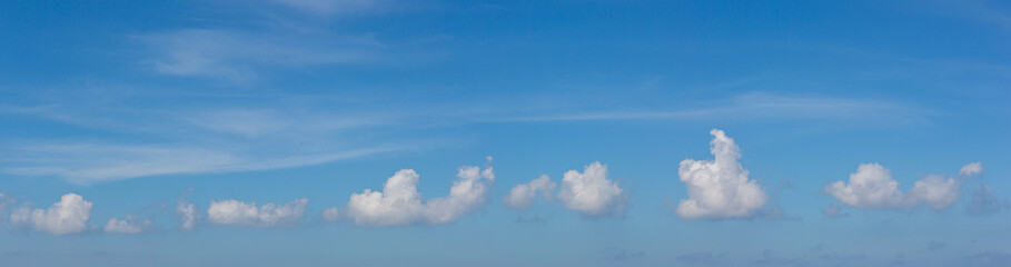 Panorama blue sky background with tiny clouds. Sky is a beautiful patterned cloud in the daytime during the summer is a panoramic image.