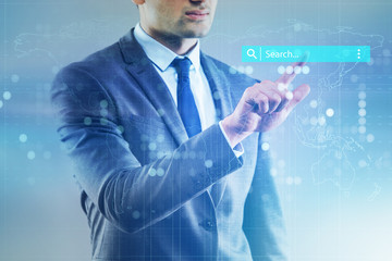 Search concept with businessman pressing button