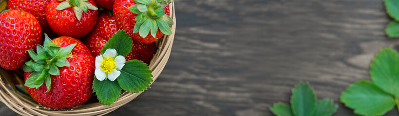 Macro shot on strawberries over wooden background.