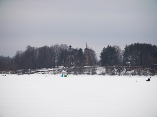 winter fishing. fishermen with tents on ice in the cold