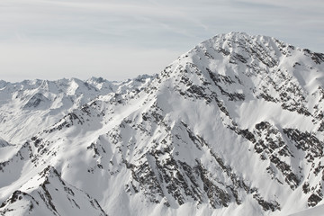 Fototapeta na wymiar Austrian Mountains in the Alps of Tyrol. Alpine Winter landscape and mountain panorama in Europe. Glacier Stubaier Gletscher Skiing area near Innsbruck. Massive rocks