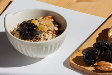 Puffed corn cakes, prunes and pecans on wooden curring board. Diet and healthy lifestyle for be fit for summer season.