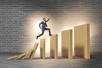 Businessman in domino effect concept