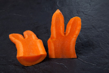A fashion trend is eating deformed and ugly vegetables. Funny carrot, similar in shape to a hare