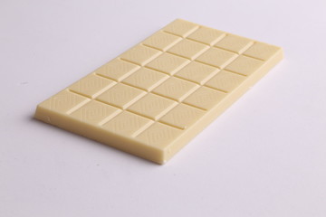 white chocolate tablet in color background