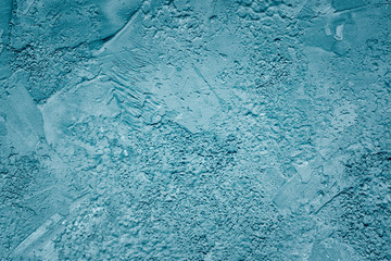 Dark turquoise unevenly plastered wall. Background for sites and layouts with concrete texture, the...