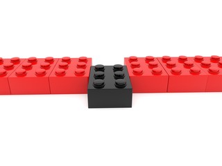A row of red toy bricks with a black brick in the center