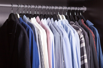 many men's shirts hanging on a hanger