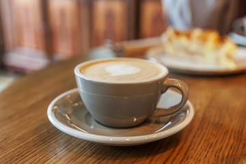 Coffee cup fresh cream organic cappuccino on table in cafe