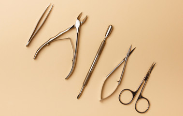 Professional manicure tools on beige background. Manicure set. Top view