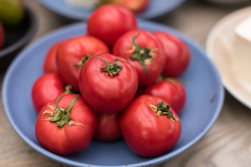 Fresh Ripe Red Tomatoes in Blue Bowl