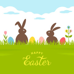 Invitation or greeting card with text Happy Easter. two rabbits are sitting in the green grass with Easter eggs.