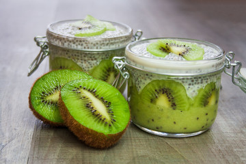 Healthy dessert: kiwi fruit mousse covered with pudding prepared from chia seeds and an almond...