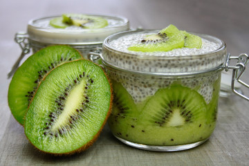  Healthy dessert: kiwi fruit mousse covered with pudding prepared from chia seeds and an almond...