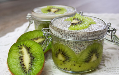  Healthy dessert: kiwi fruit mousse covered with pudding prepared from chia seeds and an almond...