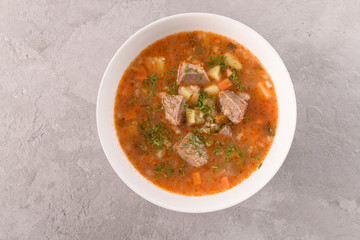 soup with beef in a white plate