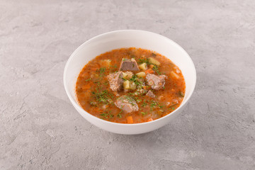 soup with beef in a white plate