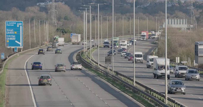Denham, UK - January 10 2020: Long-lens shot looking east towards vehicles travelling in and out of London on the busy M40 near Denham