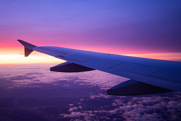 Fototapeta na wymiar wing view plane in the sky sunrise