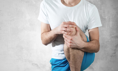 Knee pain The man is holding his knee, he feels pain. Medical and pharmaceutical concept. People's...