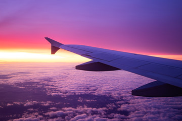 Obraz premium wing view plane in the sky sunrise