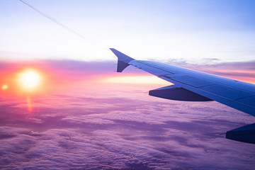 Obraz premium wing view plane in the sky sunrise