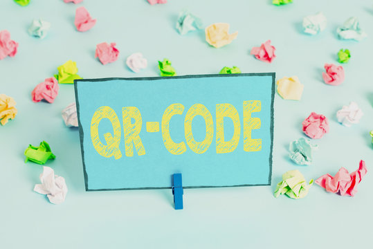 Writing note showing Qr Code. Business concept for the trademark for a type of matrix barcode A machinereadable code Colored crumpled papers empty reminder blue floor background clothespin
