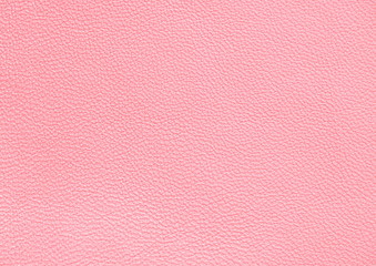 The texture of genuine leather. Pink background.