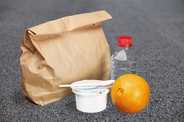Healthy lunch food and orange on desk