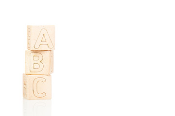 Wooden cubes with letters ABC on a white background