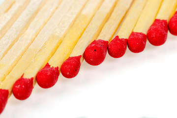 matches with a red head on a white background