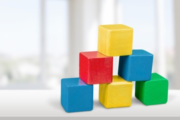 Wooden colored building cubes on the table