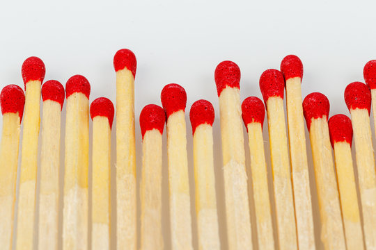 matches with a red head on a white background