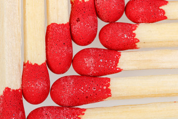 matches with a red head on a white background