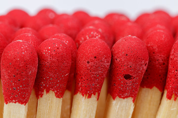 matches with a red head on a white background