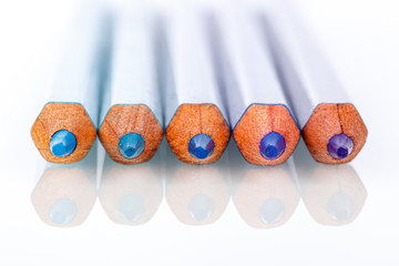 blue and violet pencil on white background