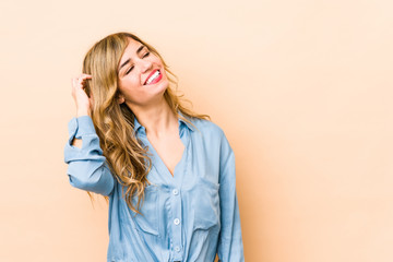 Young blonde caucasian woman celebrating a victory, passion and enthusiasm, happy expression.