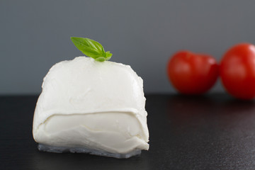 Large mozzarella with a blackened slate board.