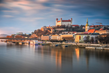 Fototapeta na wymiar Cityscape of Bratislava, Slovakia at Sunset as Seen from a Bridge over Danube River Towards Old Town of Bratislava.