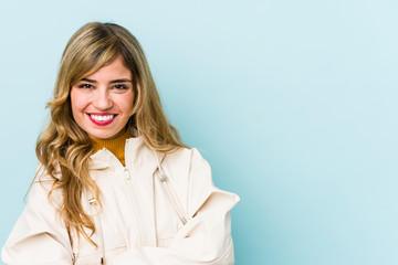 Young blonde caucasian woman who feels confident, crossing arms with determination.