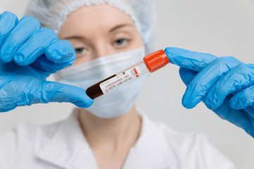 Doctor holds blood sample for Coronavirus testing on white background,closeup,Wuhan,China. 2019-nCoV pandemic, MERS.